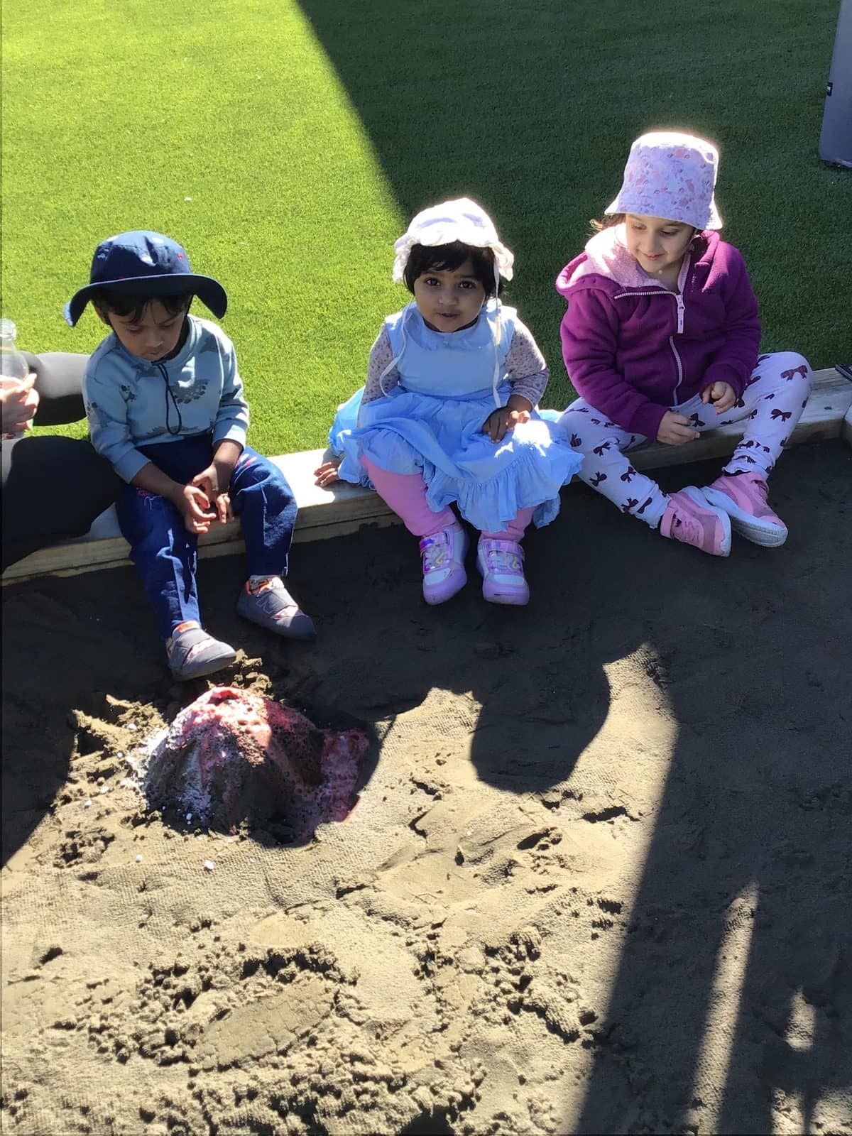 Kenepuru landing children sitting in sandpit sunshine